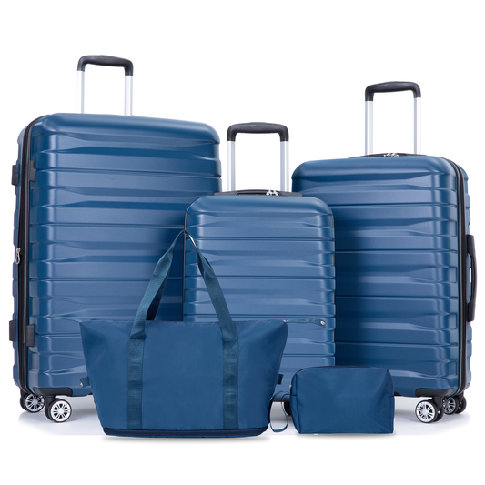 Set of four blue hardside luggage pieces including three suitcases and a duffel bag