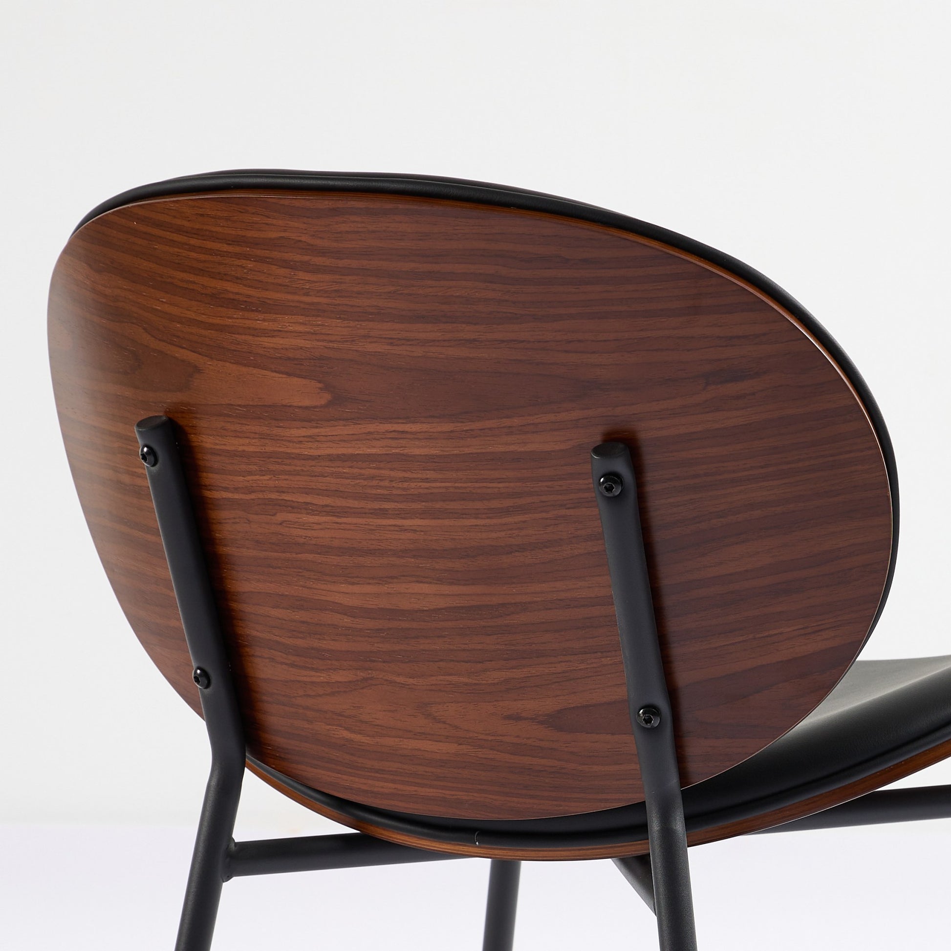 Walnut veneer dining chair with black metal frame and curved back