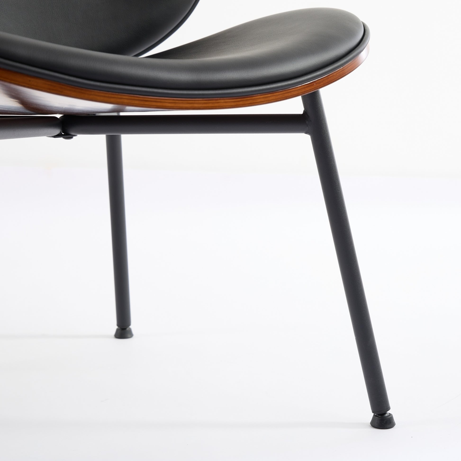 Black leather and wood accent chair with minimalist metal legs