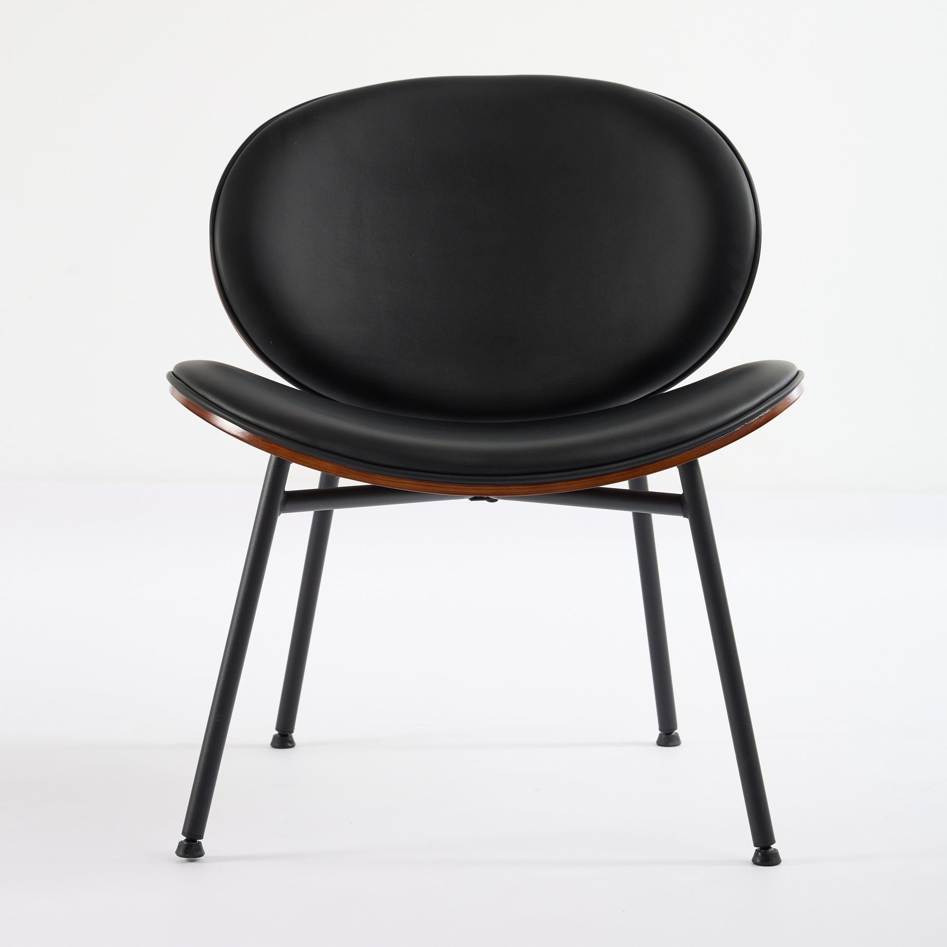 Black leather dining chair with curved wood accent and black metal legs