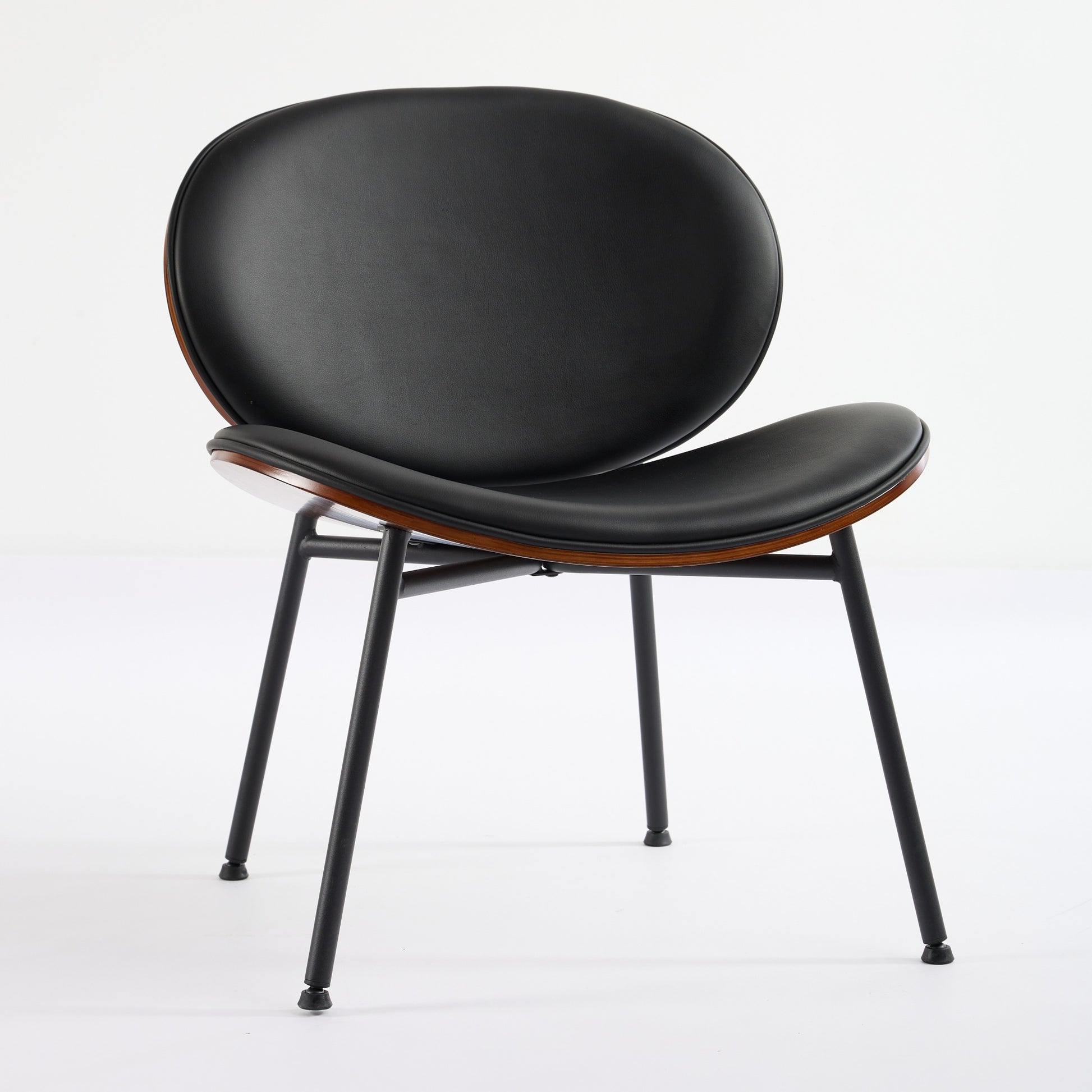 Black leather molded chair with wooden trim and matte black metal legs for modern living spaces