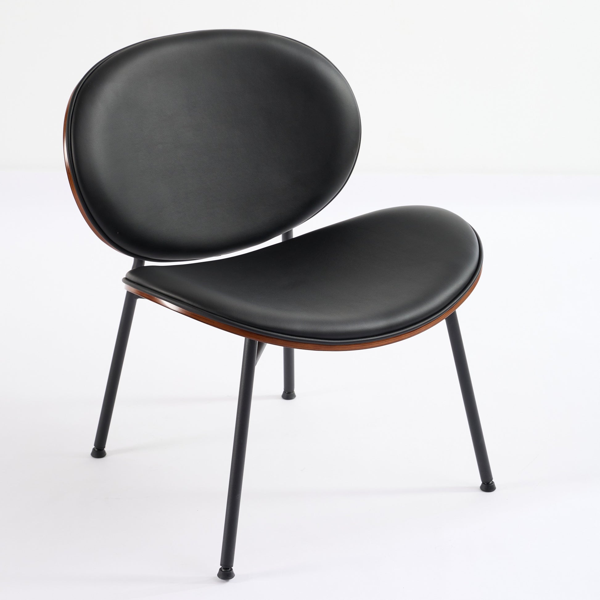 Black leather accent chair with curved wooden trim and slim metal legs