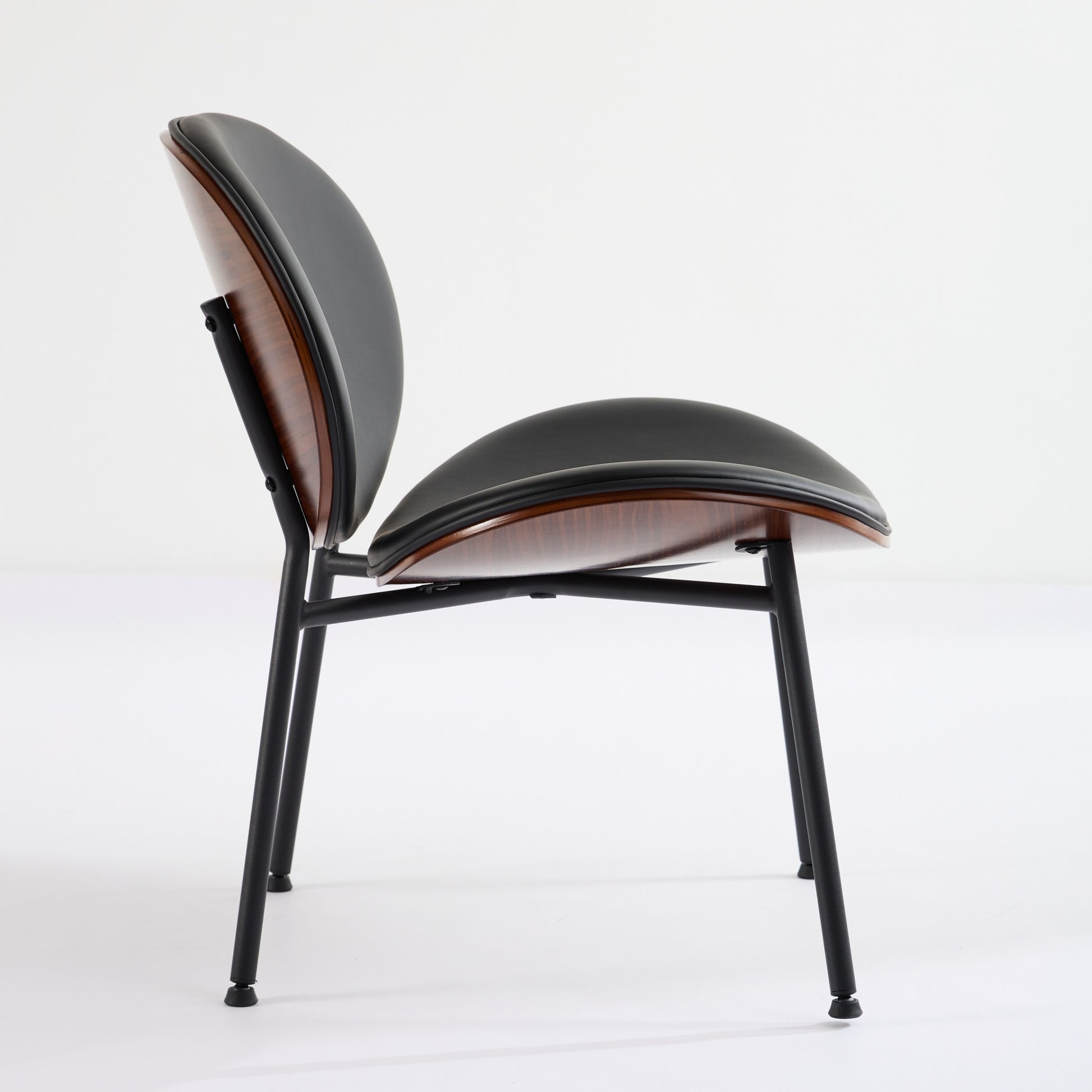 Black upholstered modern dining chair with wood veneer accents and black metal legs