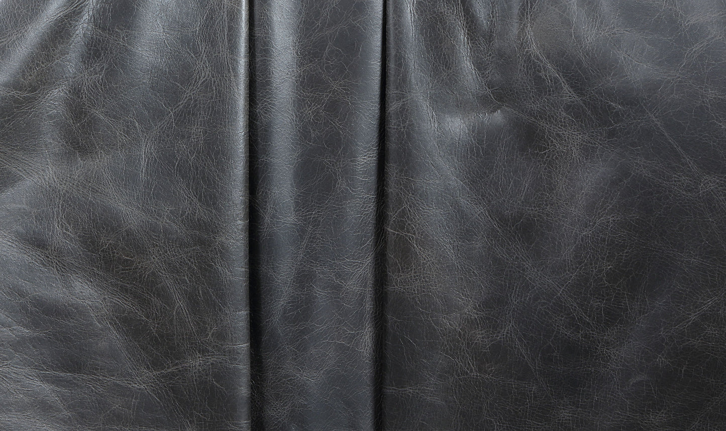 Closeup of textured charcoal grey faux leather upholstery material