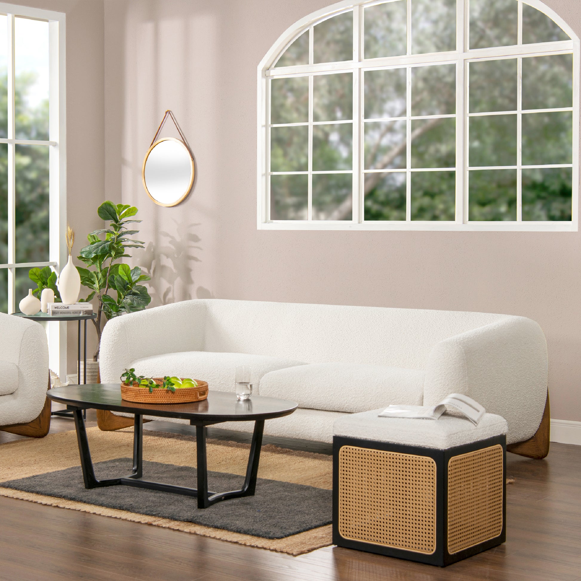 Plush boucle fabric sofa in offwhite featuring a curved silhouette and natural wood legs