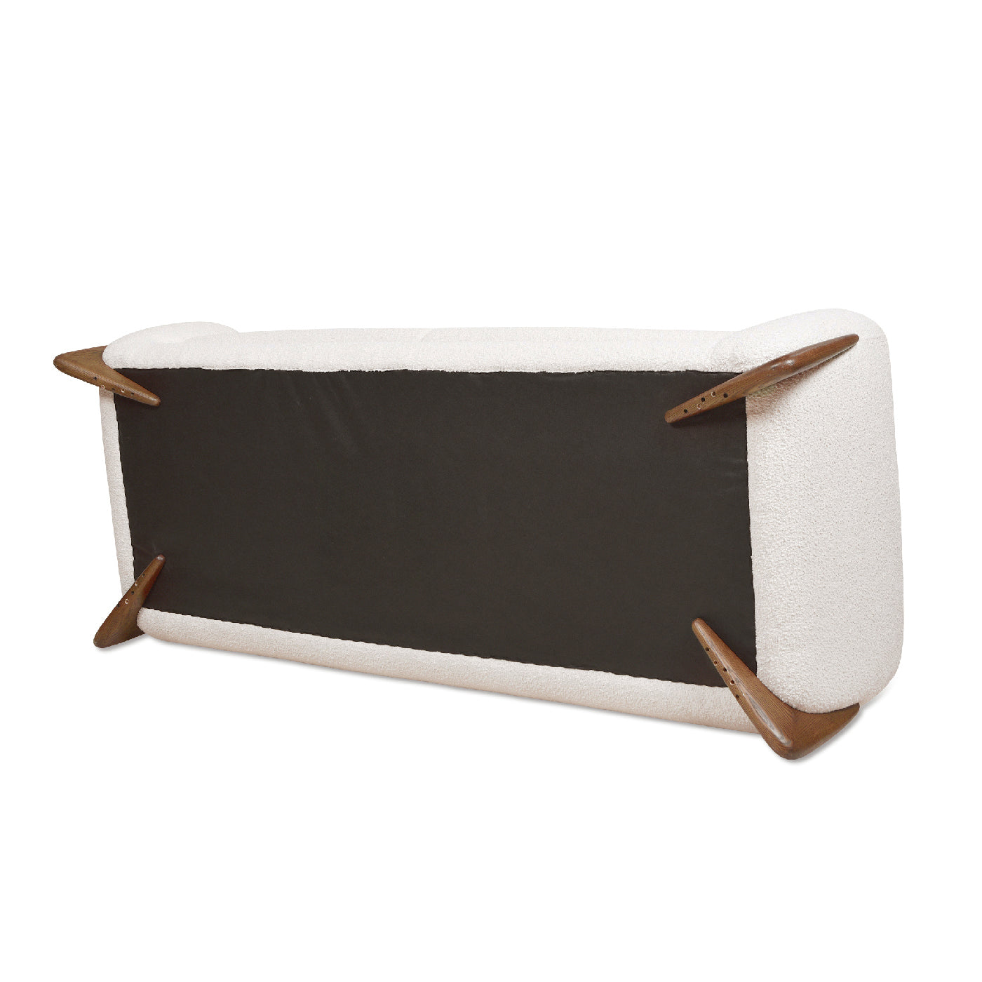 White boucle sofa viewed from underneath showcasing wooden tapered legs and dark base fabric