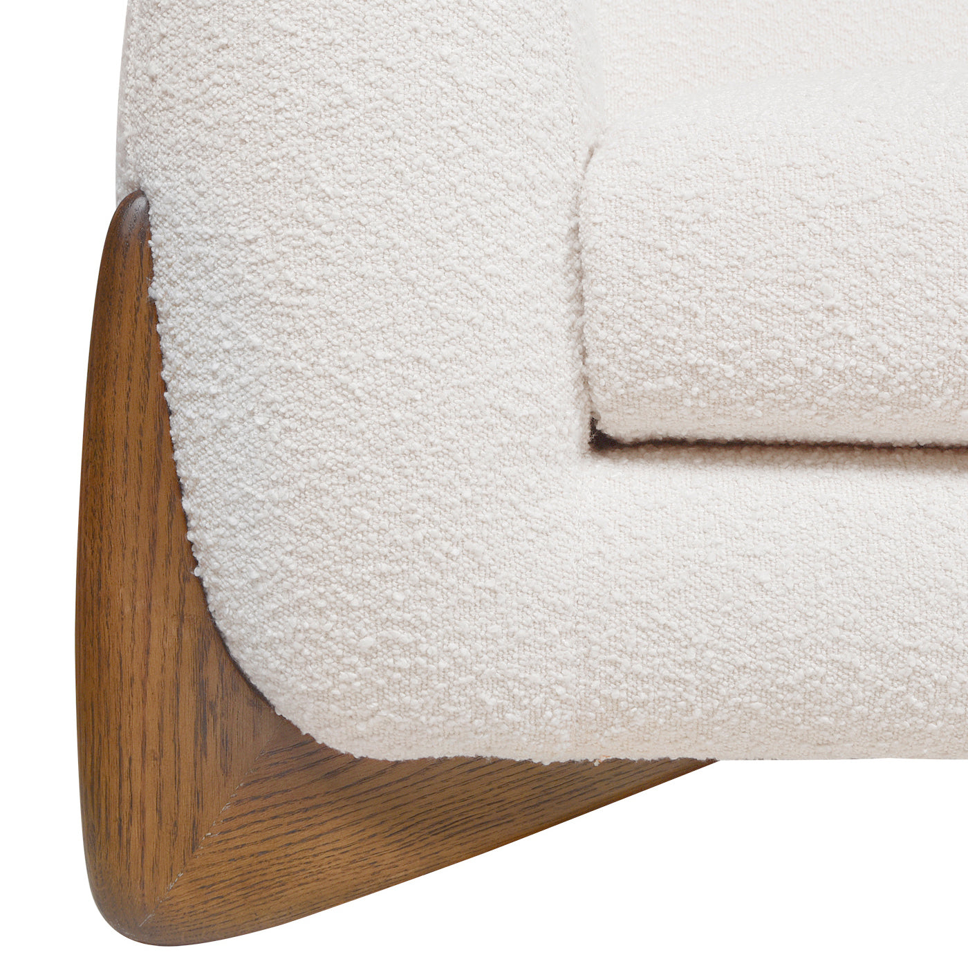 Close up of cream boucle armchair with angled wood base