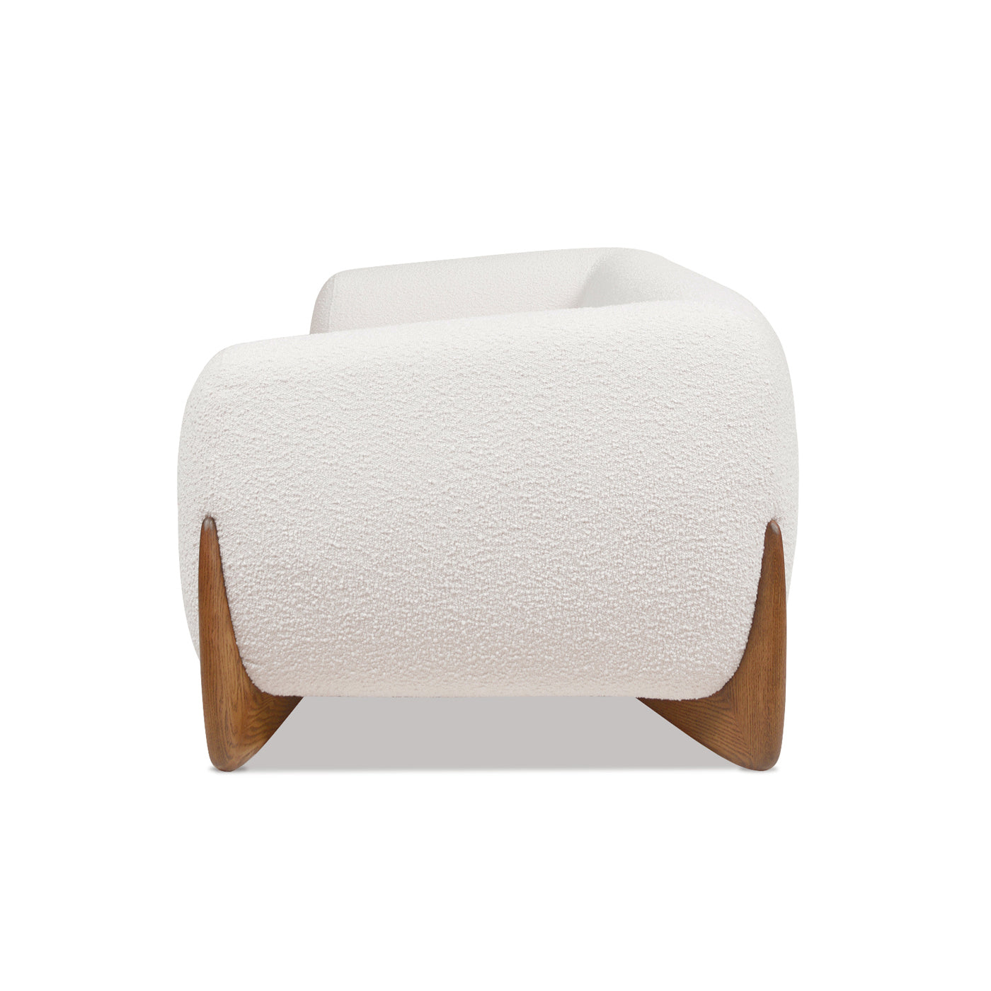 Plush ivory boucle armchair with curved modern silhouette and wooden tapered legs