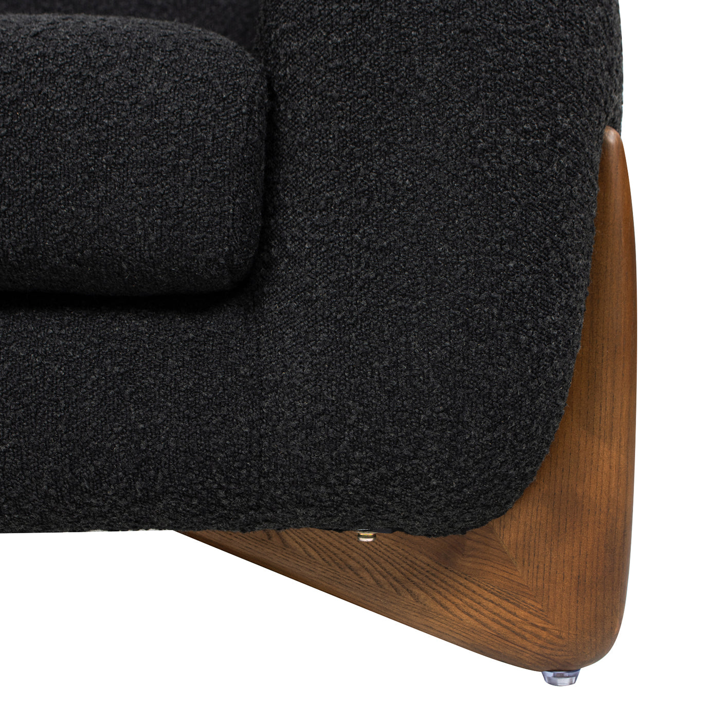 Dark grey textured fabric sofa armrest with rich wood accent base and metal feet