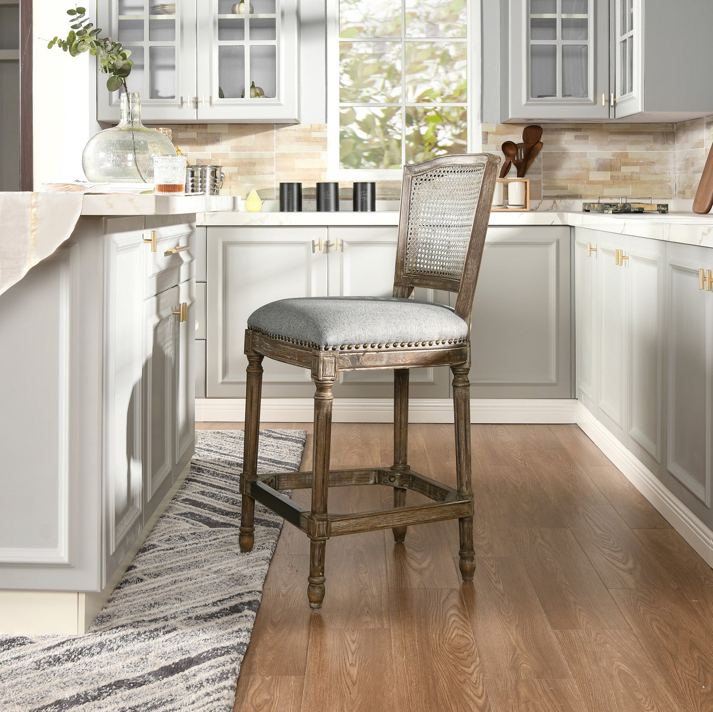 Distressed wood bar stool with woven cane back and upholstered gray seat