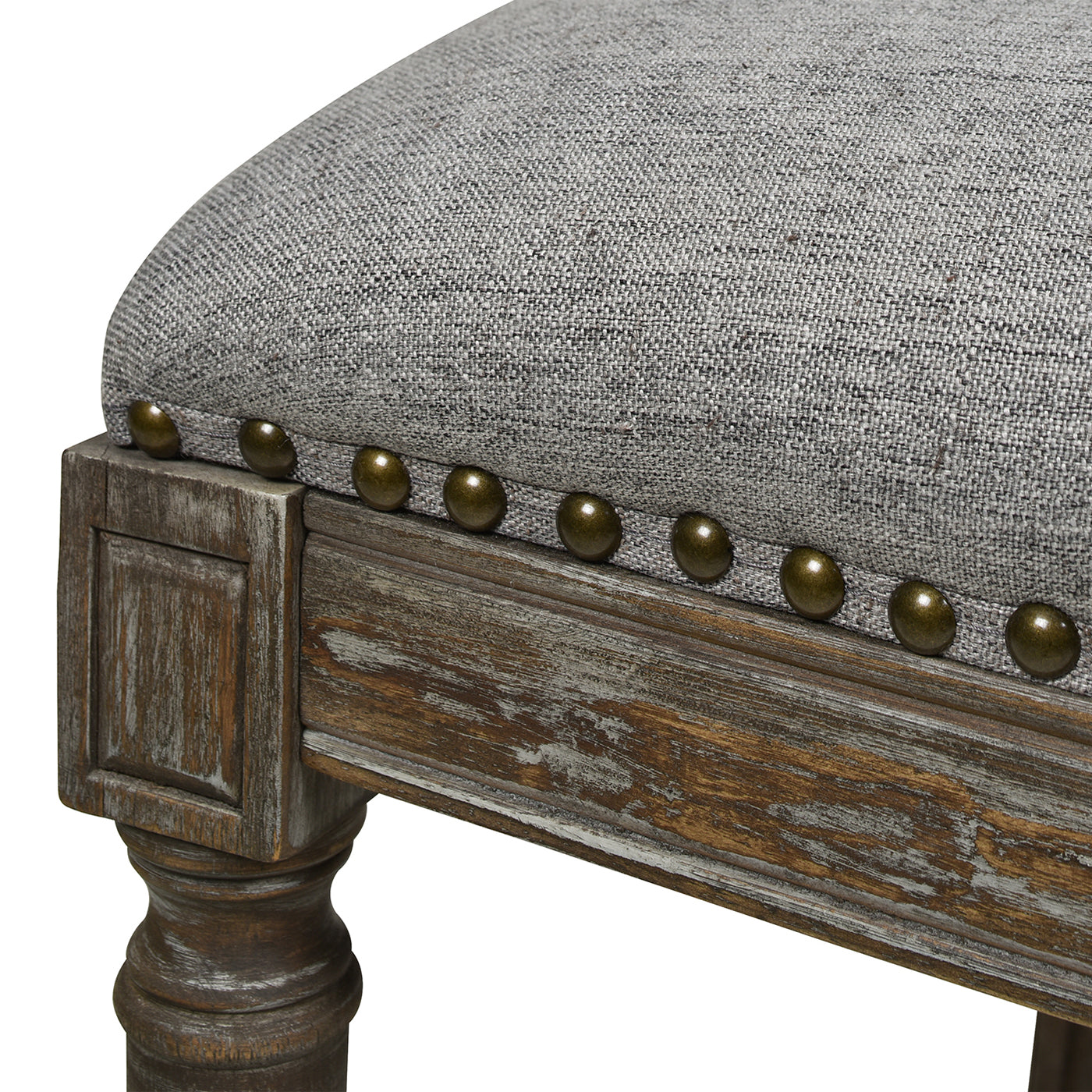 Grey linen upholstered stool with antique brass nailhead trim and distressed wood frame
