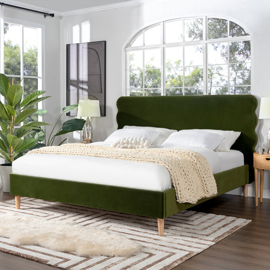 Green velvet bed frame with scalloped headboard and wooden legs