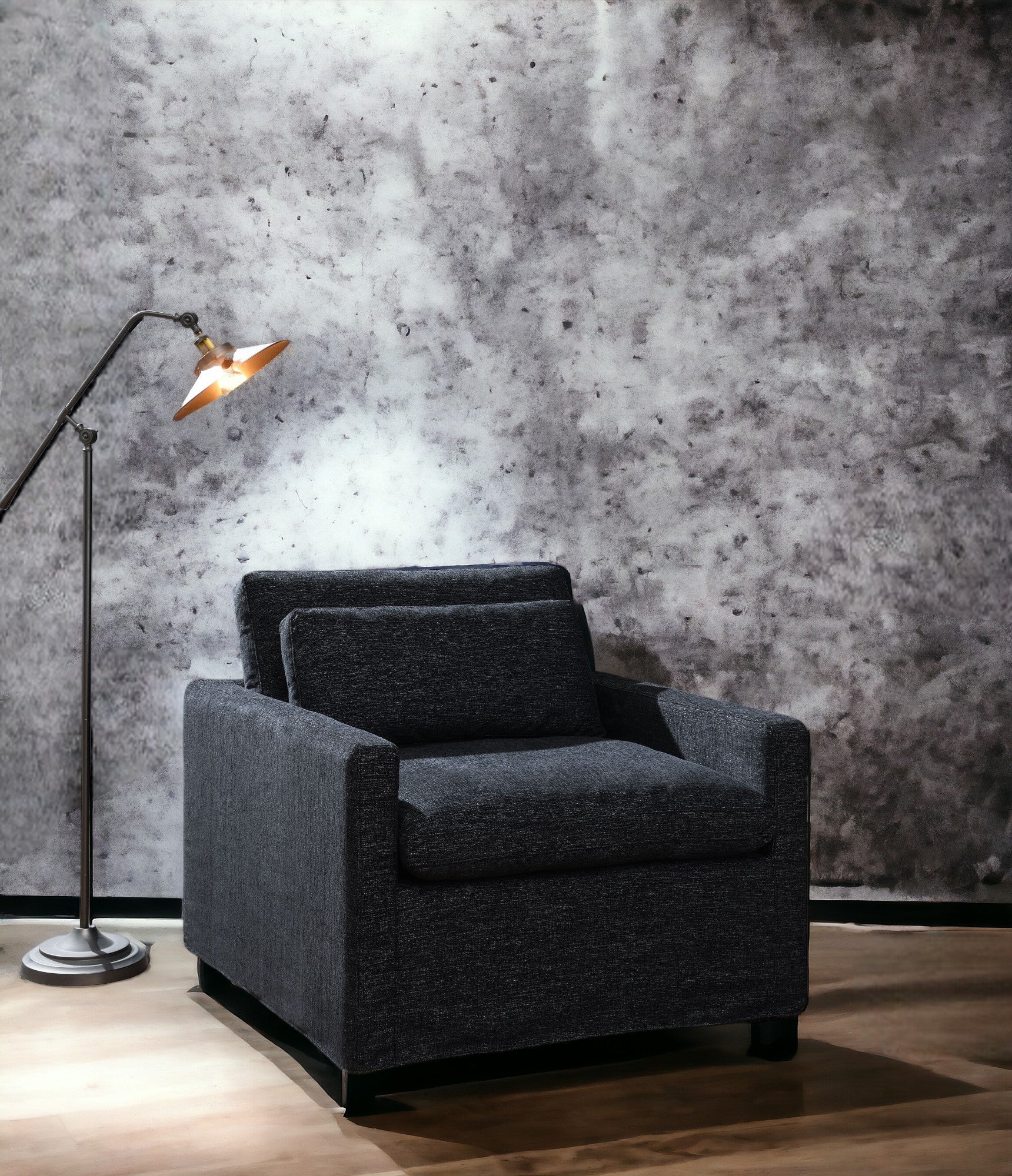 Modern charcoal grey upholstered armchair with clean lines perfect for contemporary living spaces