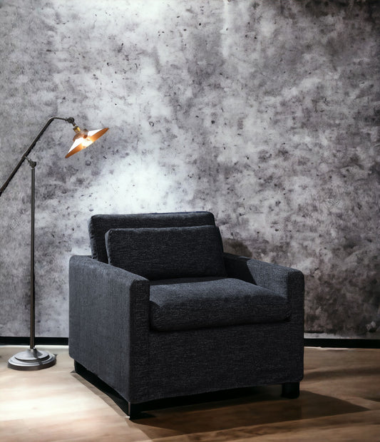 Modern charcoal grey upholstered armchair with clean lines perfect for contemporary living spaces