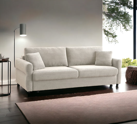 Light beige corduroy fabric couch with two plush seat cushions and three throw pillows