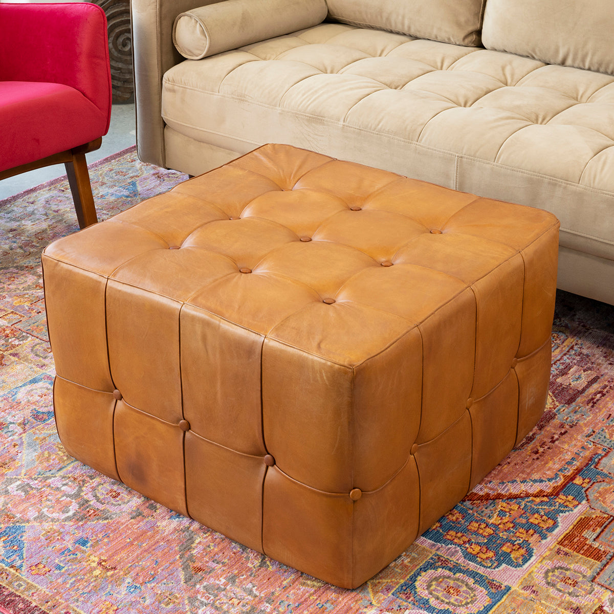 Tufted cognac leather ottoman with button details perfect for living room seating