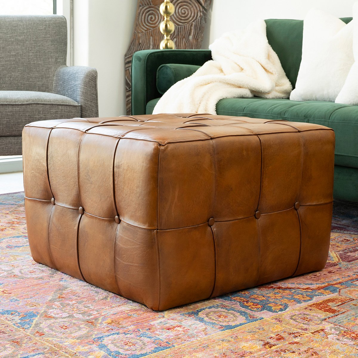 Tufted caramel brown leather ottoman with button detail perfect for footrest or extra seating