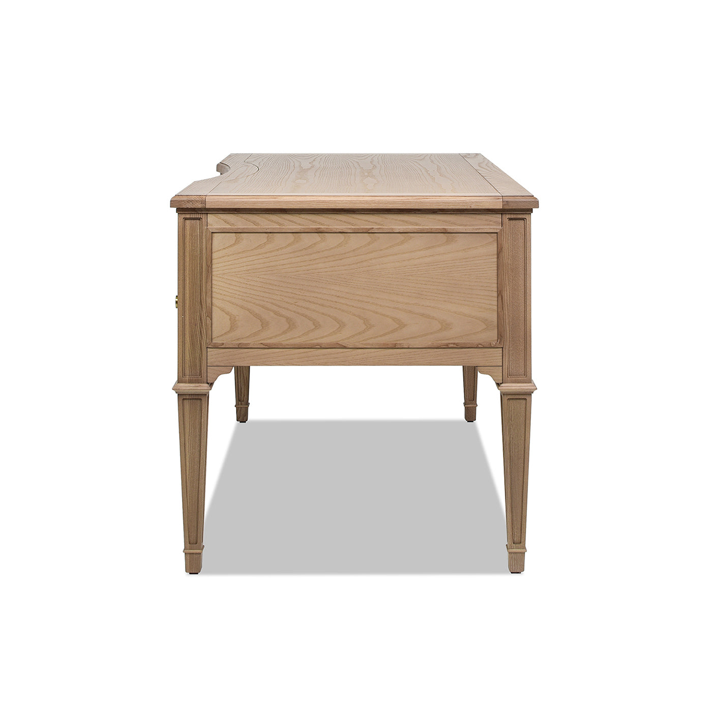 Light oak wood desk with tapered legs and ornate detailing on the front panel