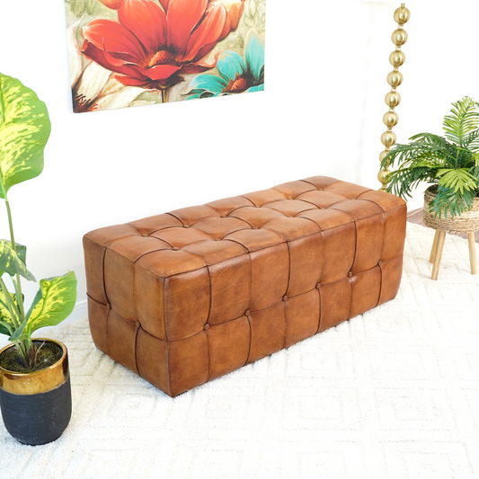 Tufted cognac leather ottoman bench with decorative stitching and button tufting