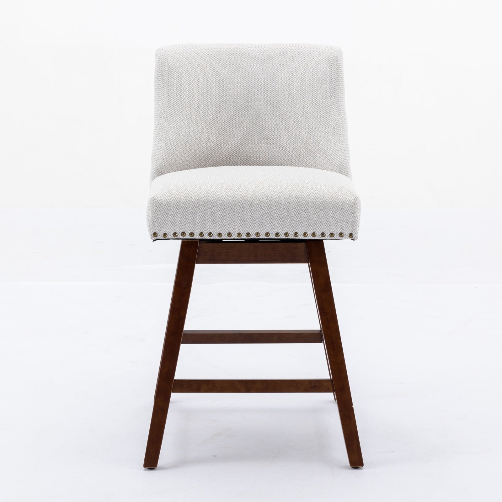 Light grey upholstered counter stool with wooden legs and brass nailhead trim