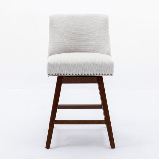 Light grey upholstered counter stool with wooden legs and brass nailhead trim
