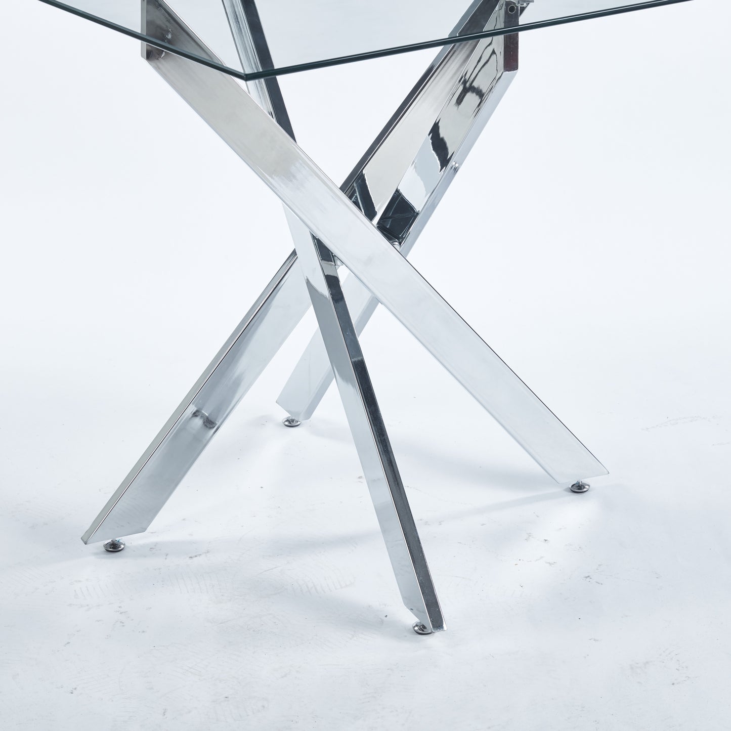 Modern dining table with clear glass top and polished chrome Xbase legs