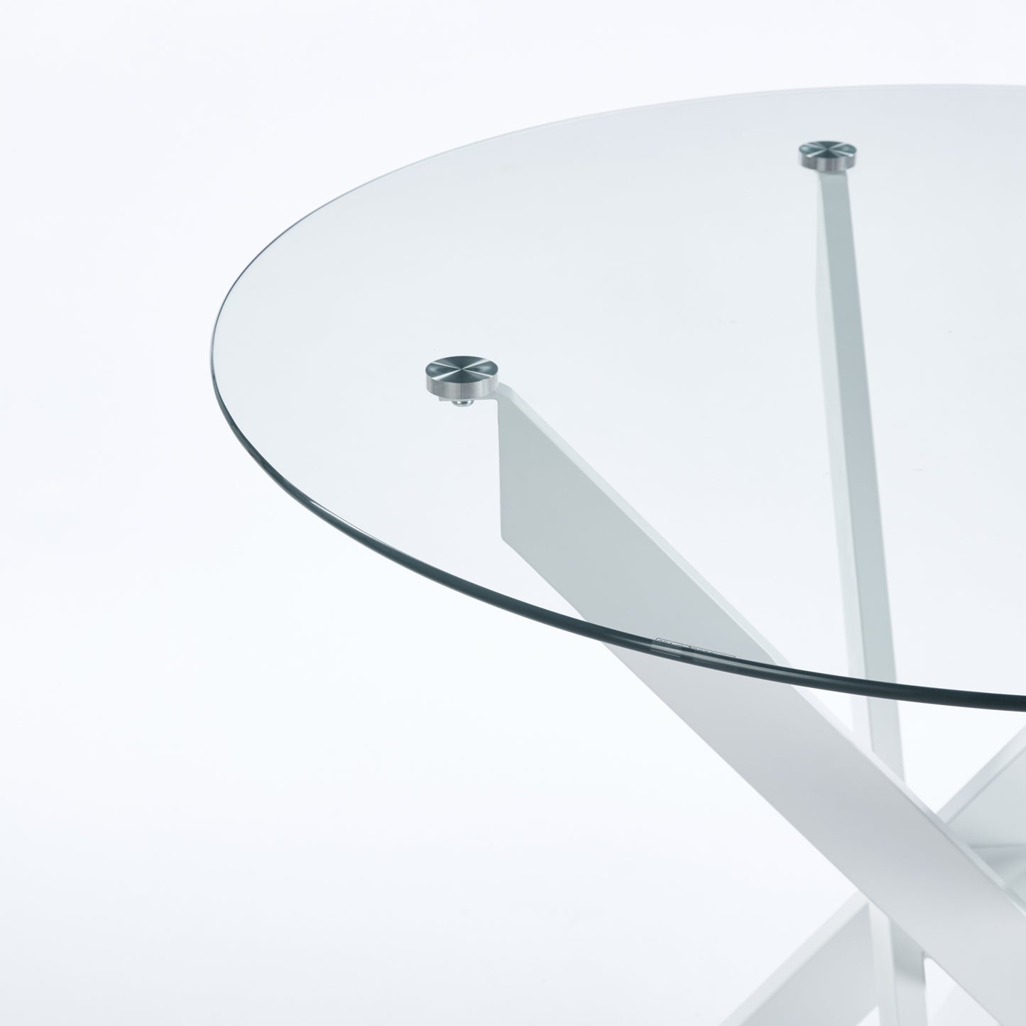 Round glass coffee table with a modern white metal base and polished chrome fasteners