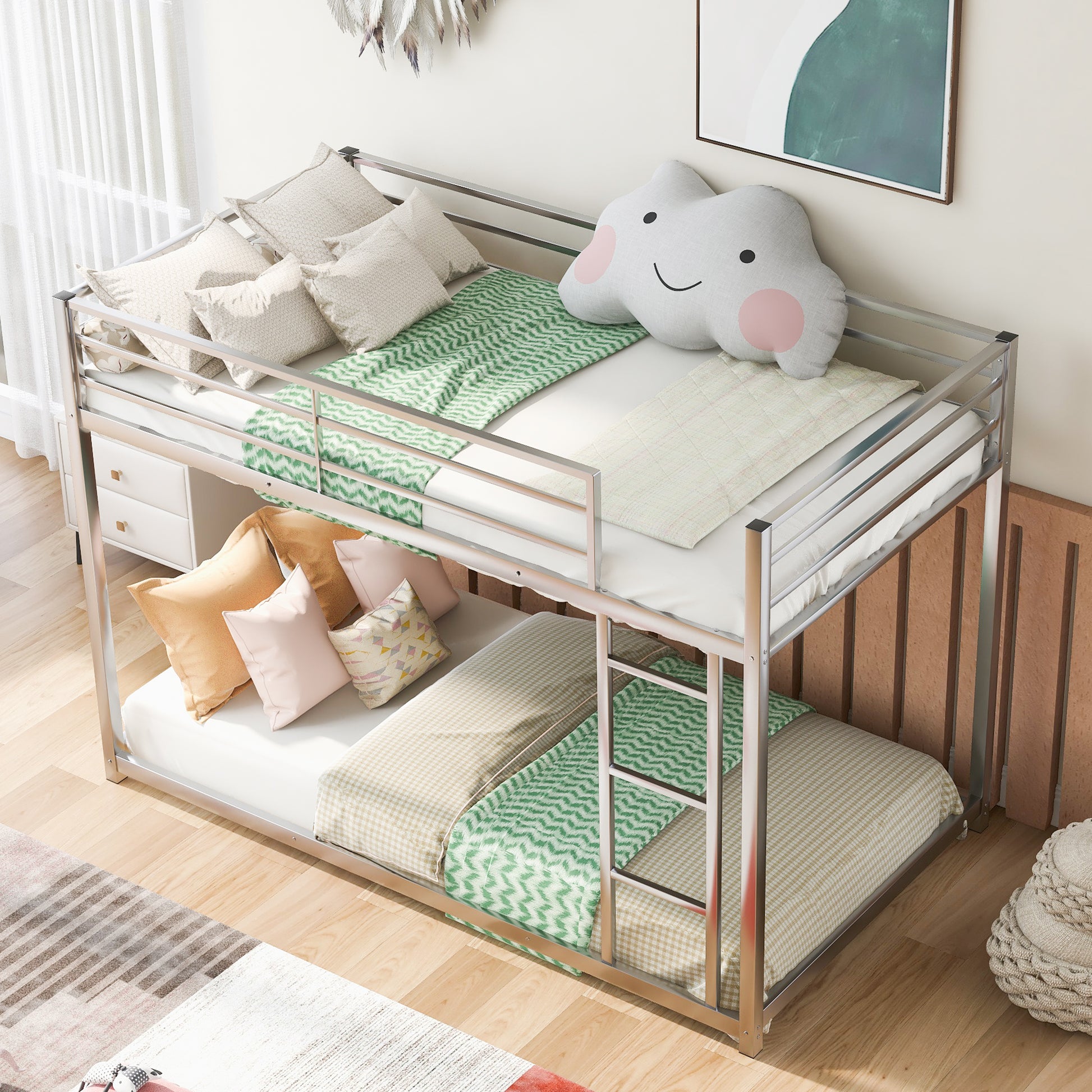 Sleek silver metal bunk bed with white mattresses green patterned blankets and decorative pillows