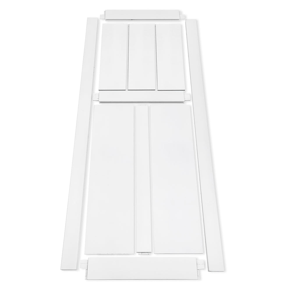 Flat packed white wooden bed frame components laid out