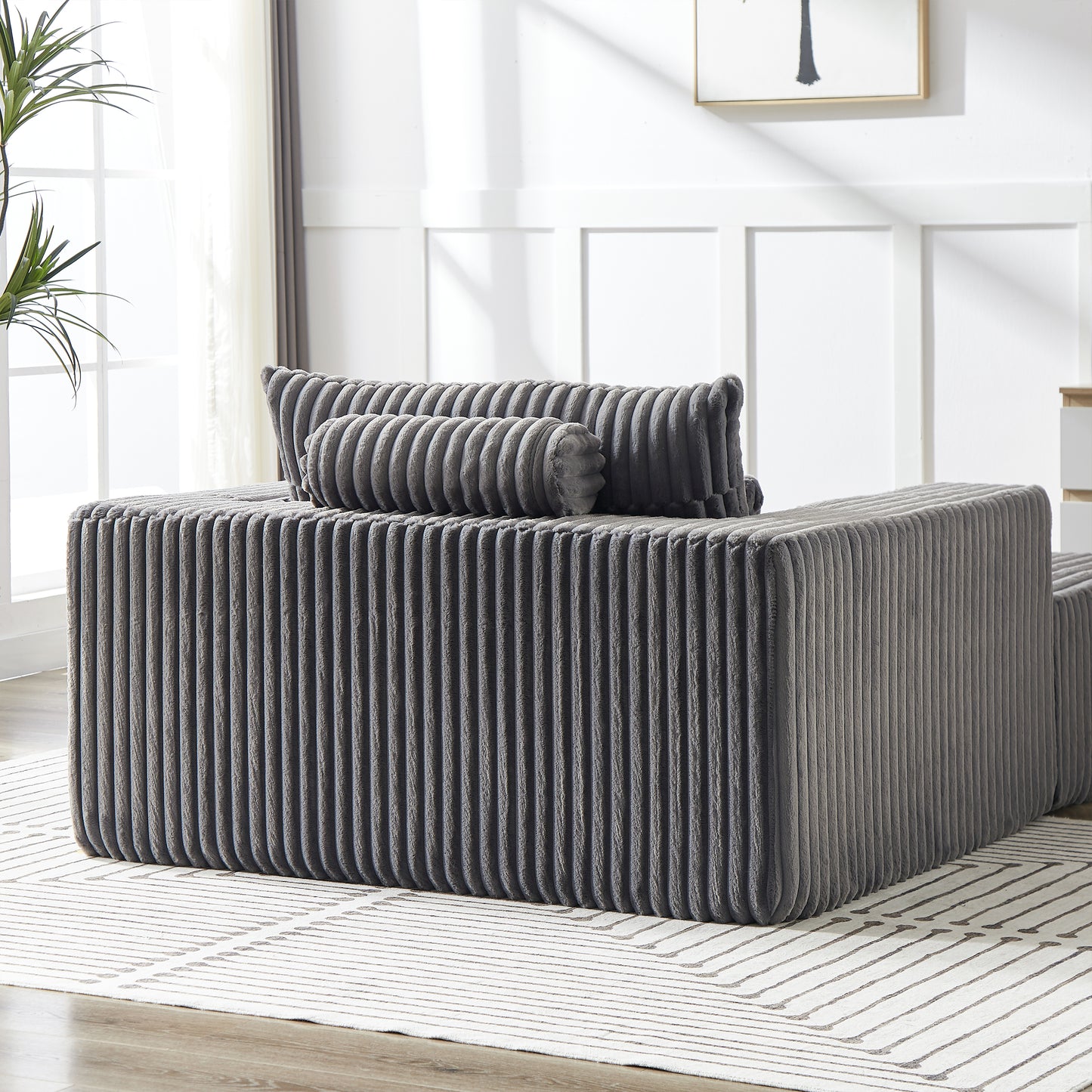 Plush grey corduroy sofa with textured pillows modern living room furniture