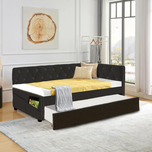 Tufted black velvet daybed with pullout trundle and gold nailhead trim