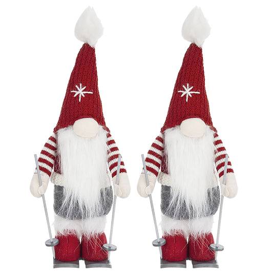 Two plush ski gnomes with red striped sleeves and white beards holding ski poles