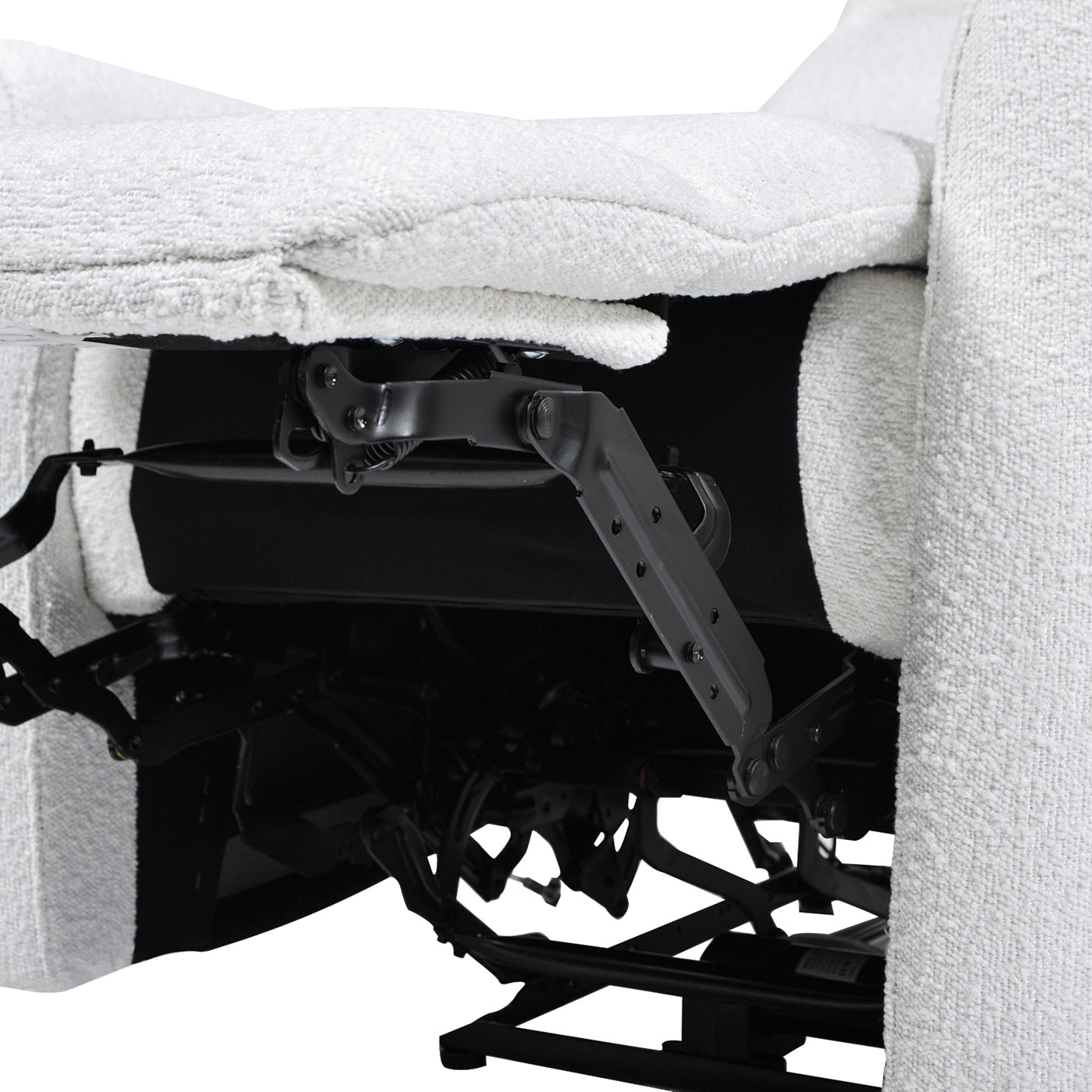 Closeup of a beige fabric recliner mechanism showing metal levers and support
