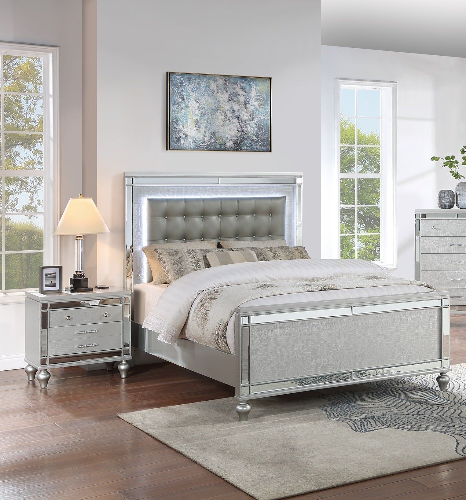 Silver upholstered bed frame with mirrored trim and LED lights