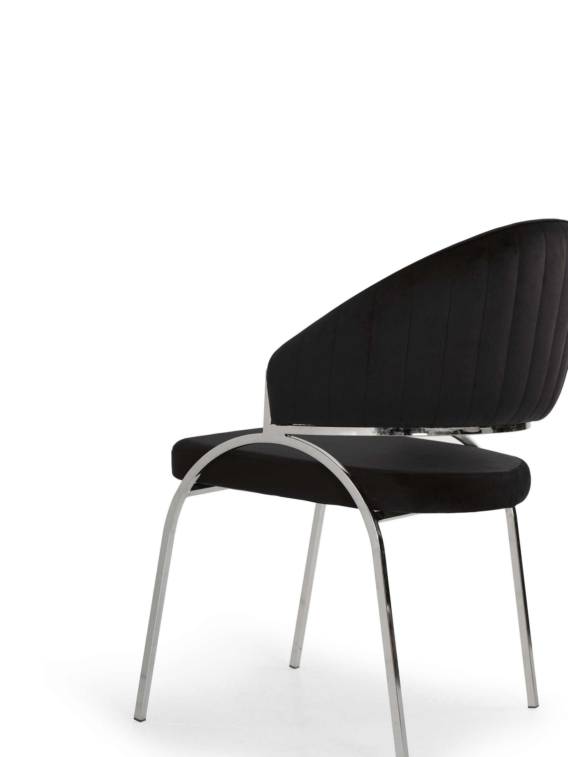 Black velvet dining chair with vertical tufting and polished chrome legs modern style