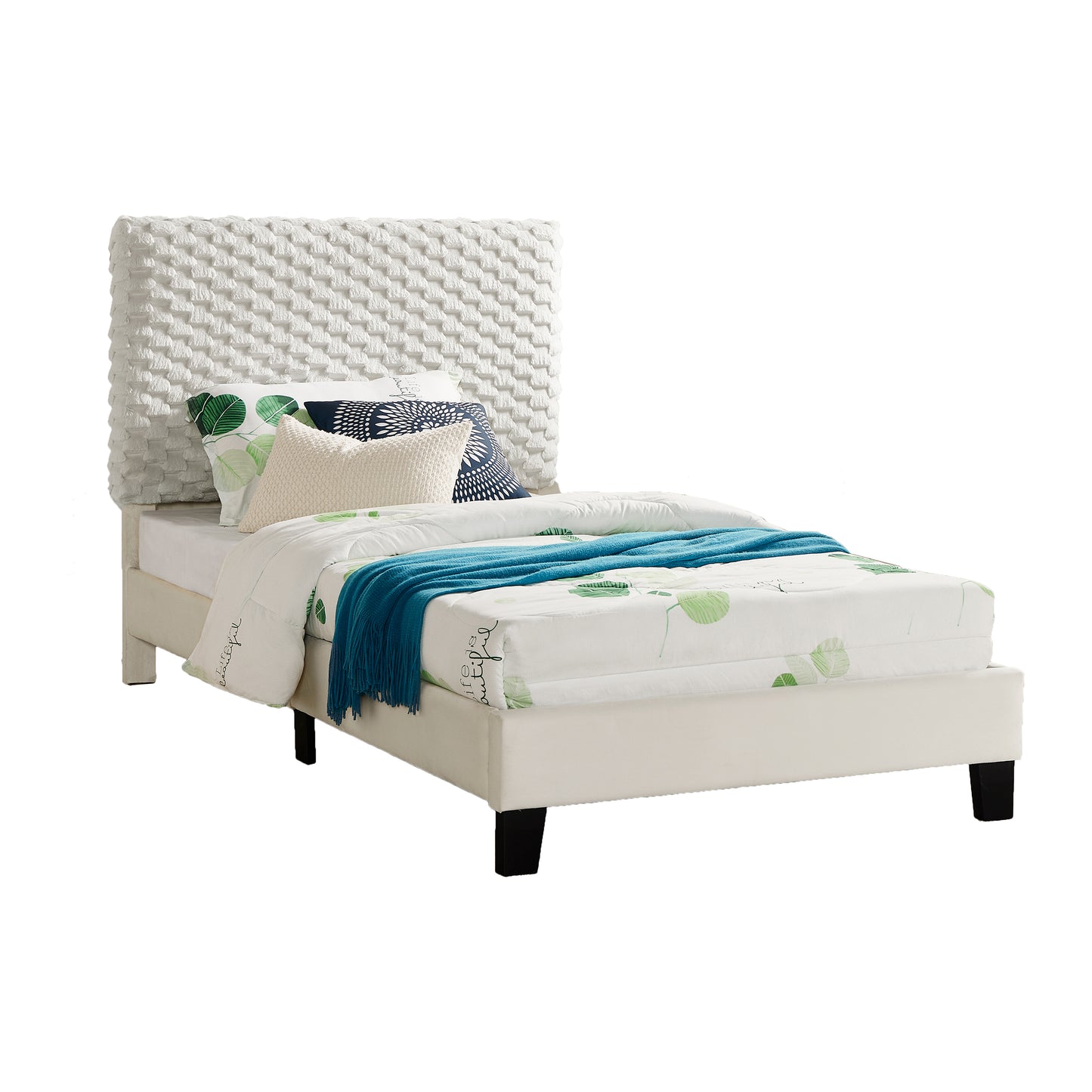 White fabric upholstered twin bed with textured headboard and leafpatterned bedding
