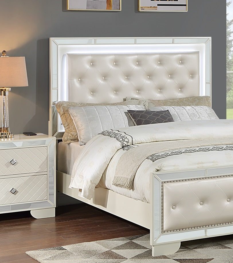 Upholstered white headboard with crystal tufting and LED lighting part of a glamorous queen size bed