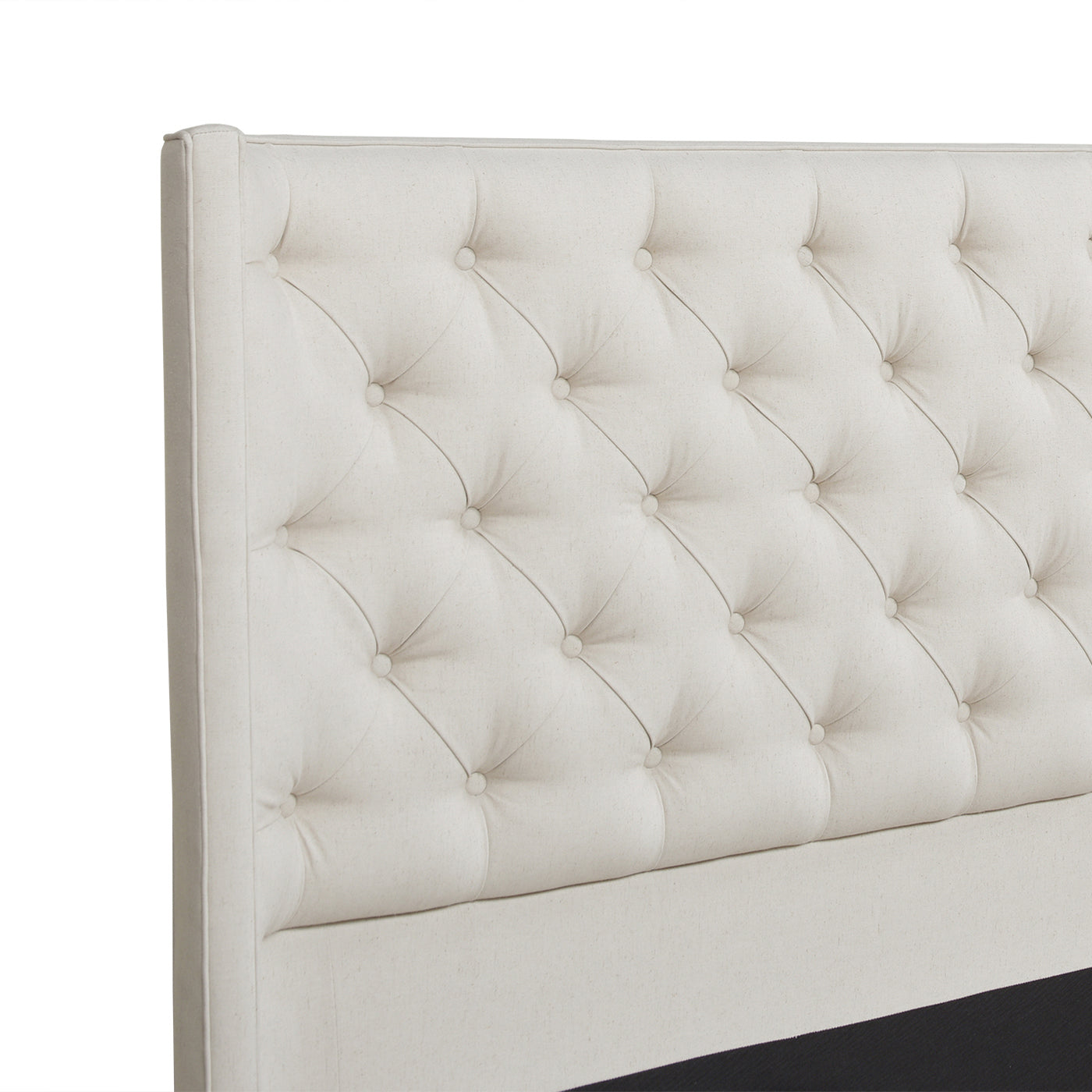 Upholstered headboard with button tufting in a neutral beige linen fabric