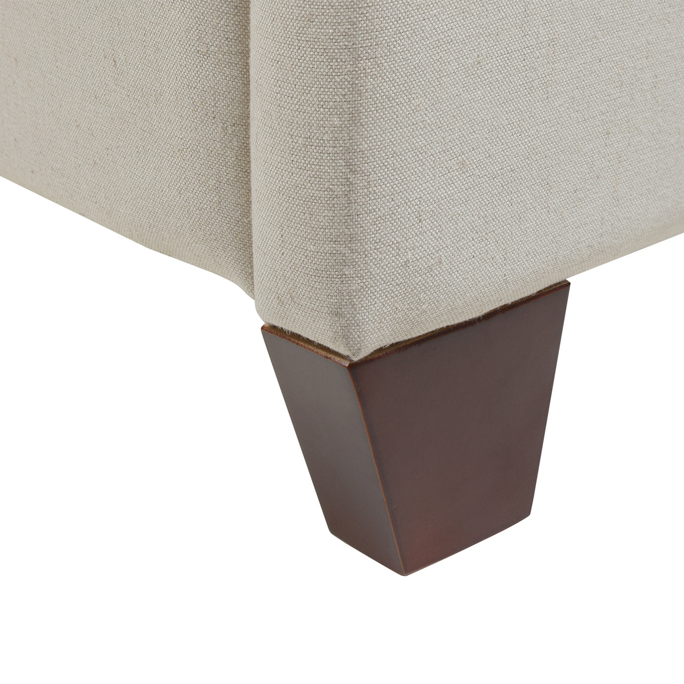 Beige upholstered furniture corner with dark wood tapered leg