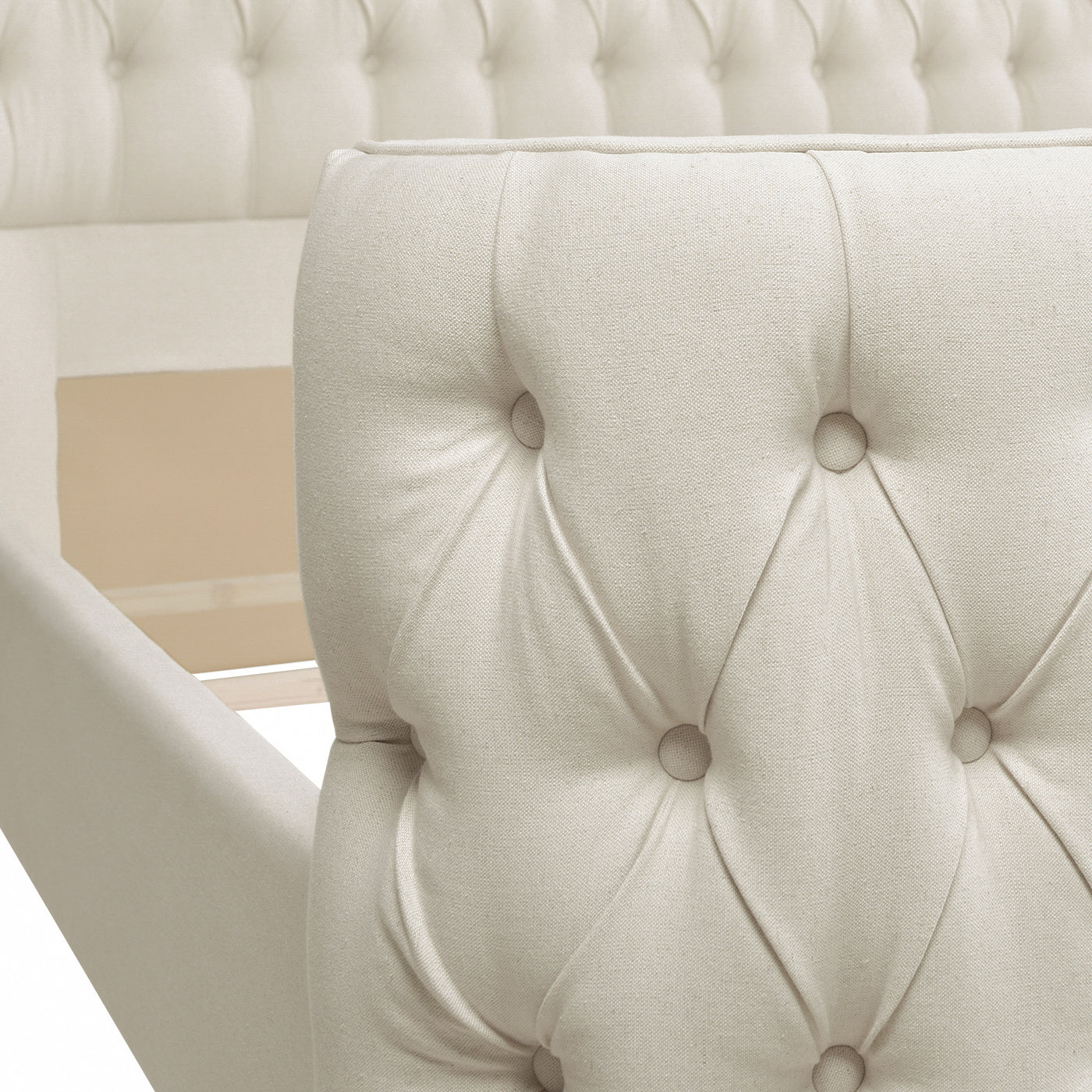 Close up of diamond tufted beige upholstered bed frame headboard detail
