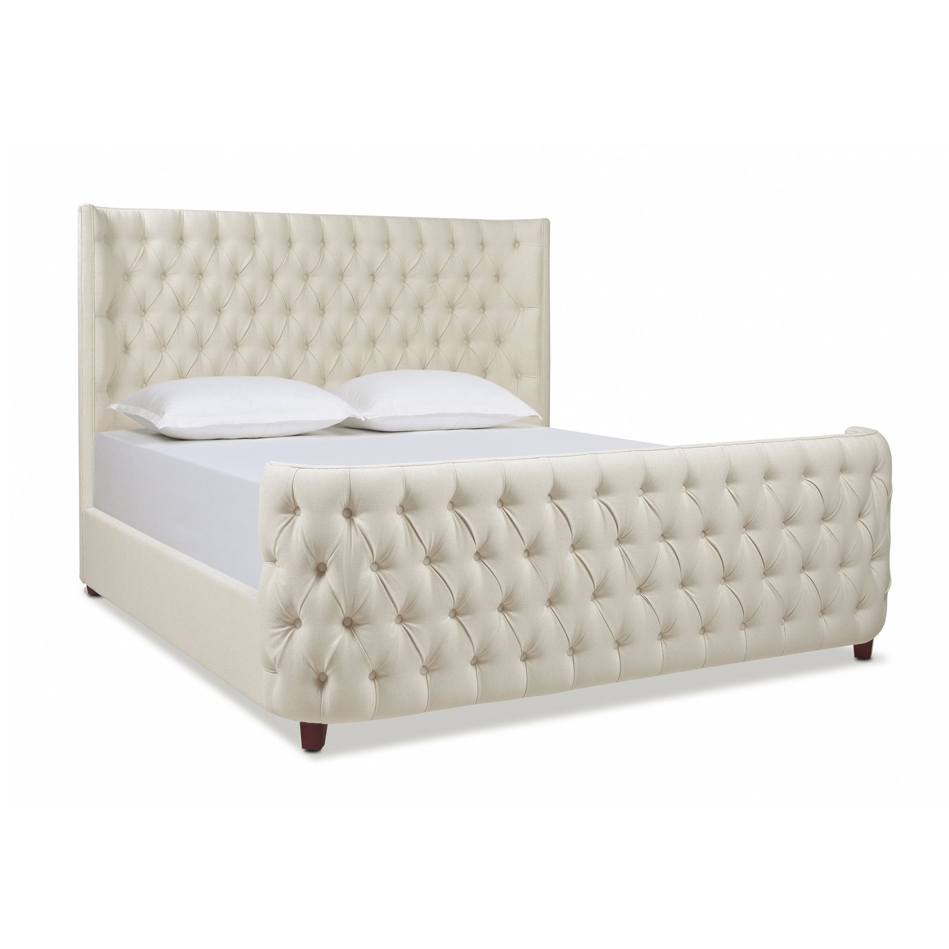 Cream upholstered sleigh bed with deep button tufting tufted headboard and curved footboard