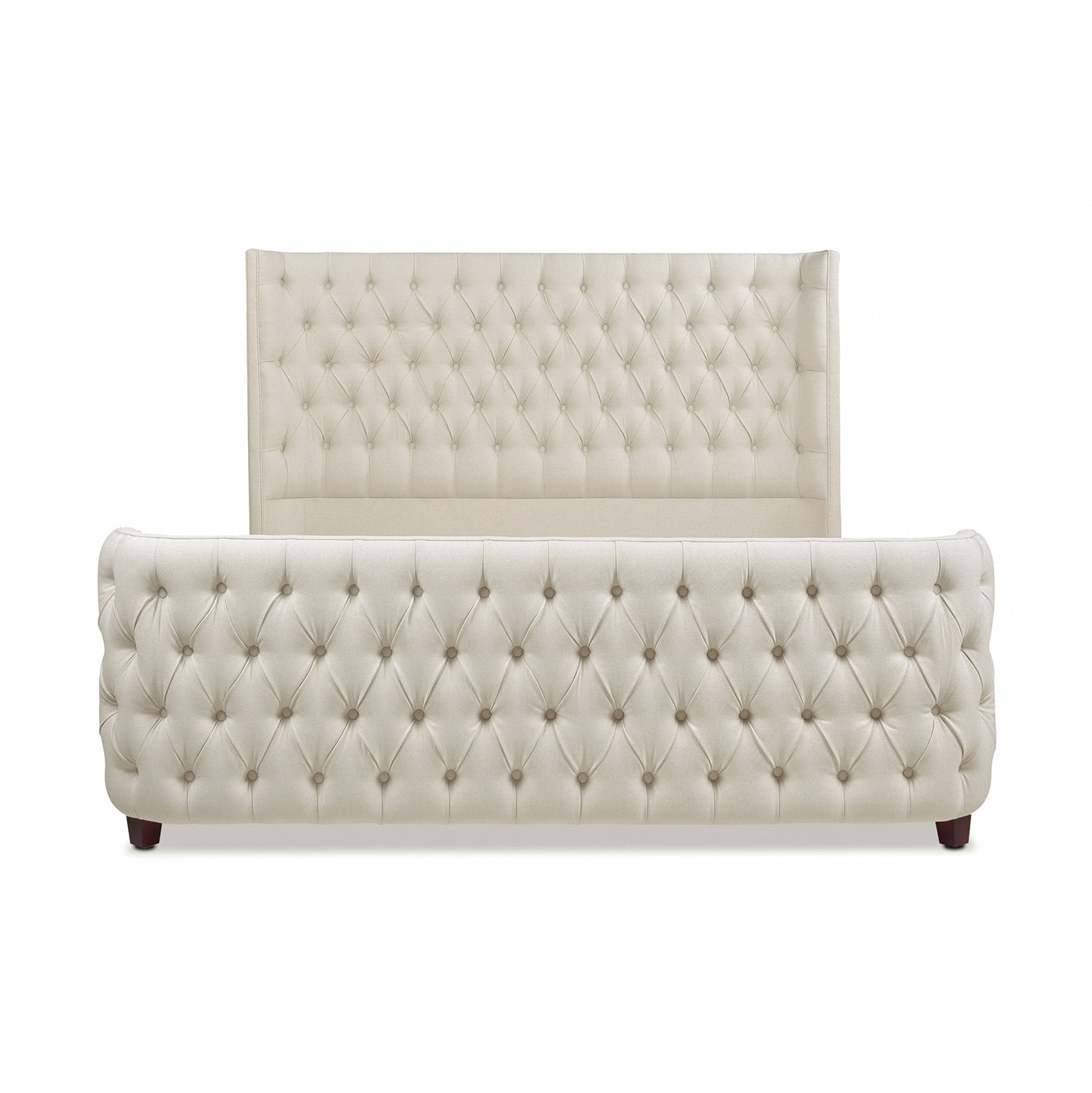 Upholstered linen sleigh bed in cream with deep button tufting on headboard and frame