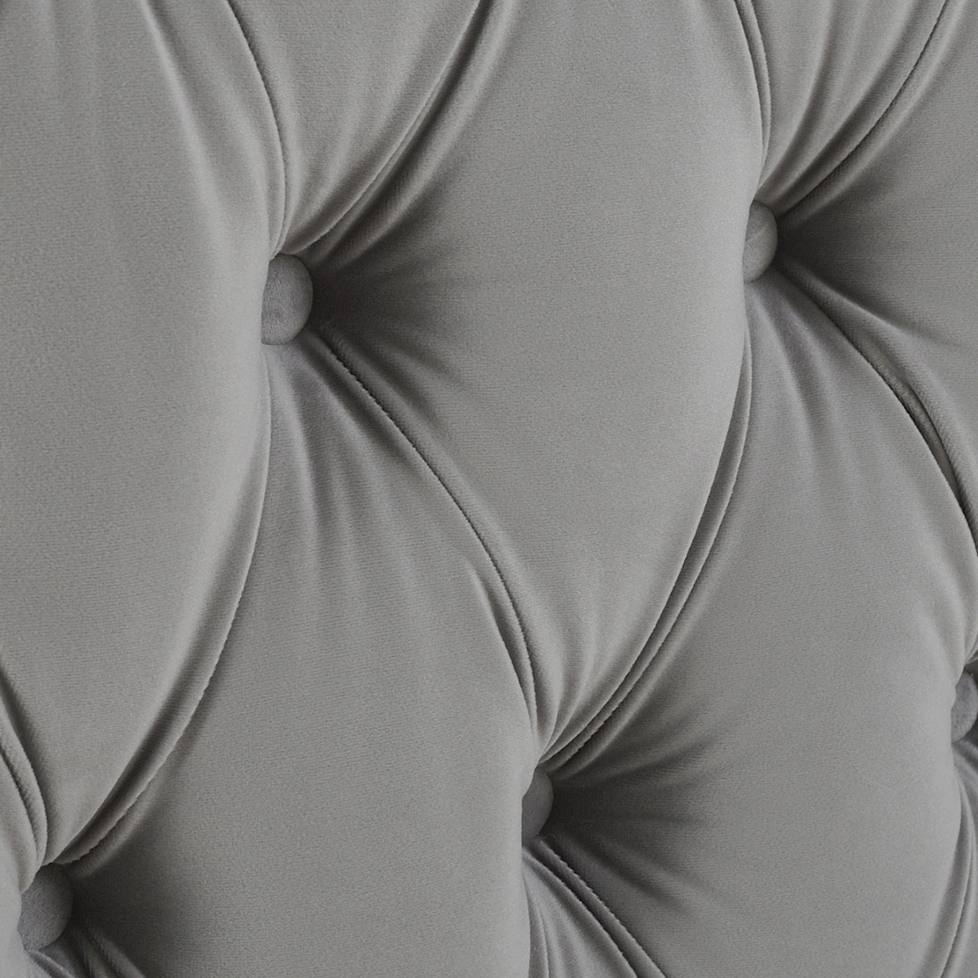 Grey velvet tufted upholstery texture on a modern armchair