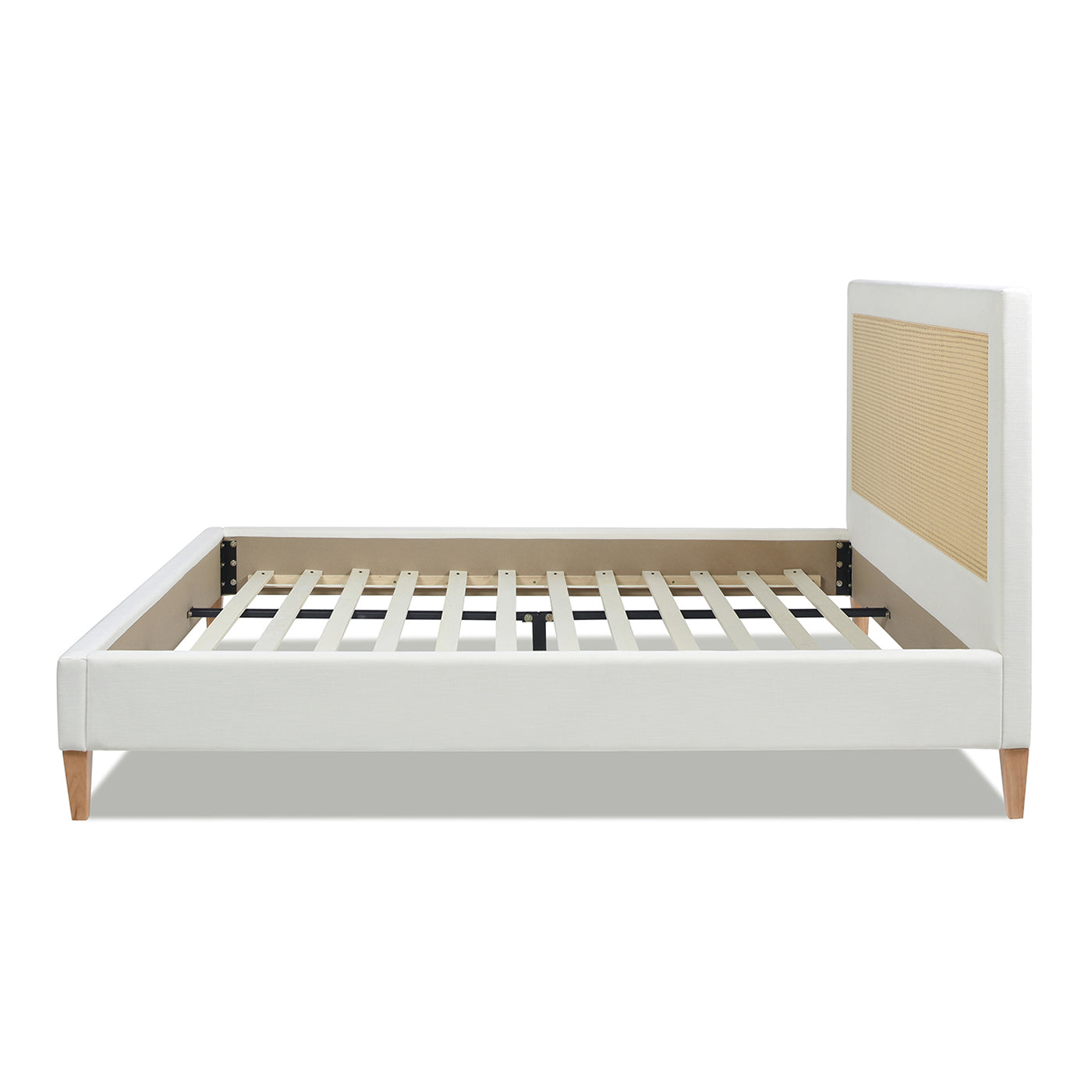 White upholstered king bed frame with woven cane headboard and wooden legs