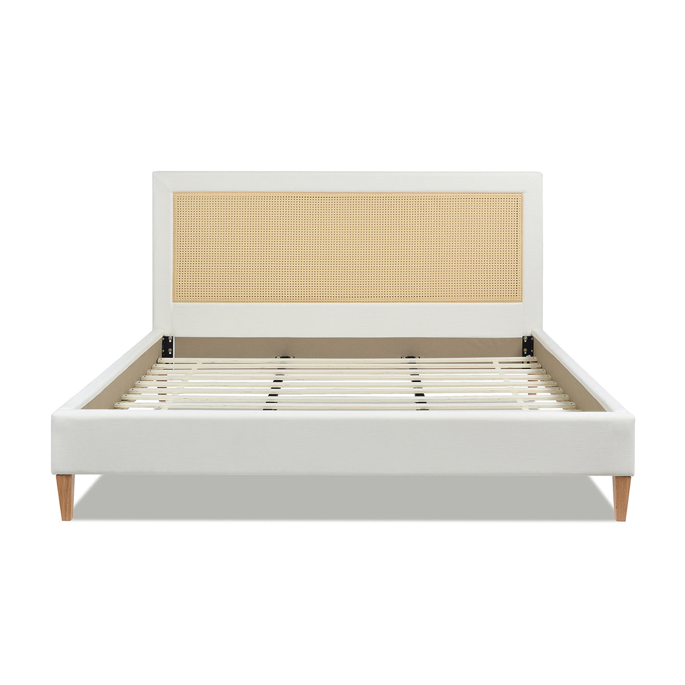 White upholstered bed frame with rattan headboard and wooden legs