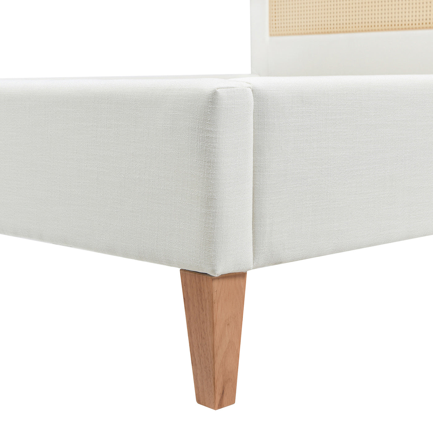 Upholstered white bed frame detail with wooden legs