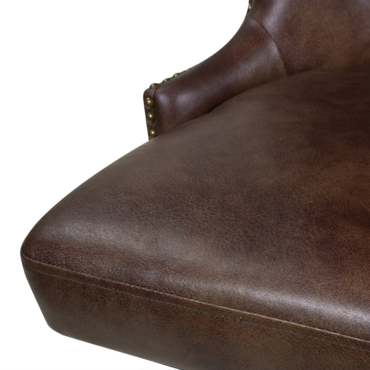 Closeup of distressed brown faux leather armchair with nailhead trim