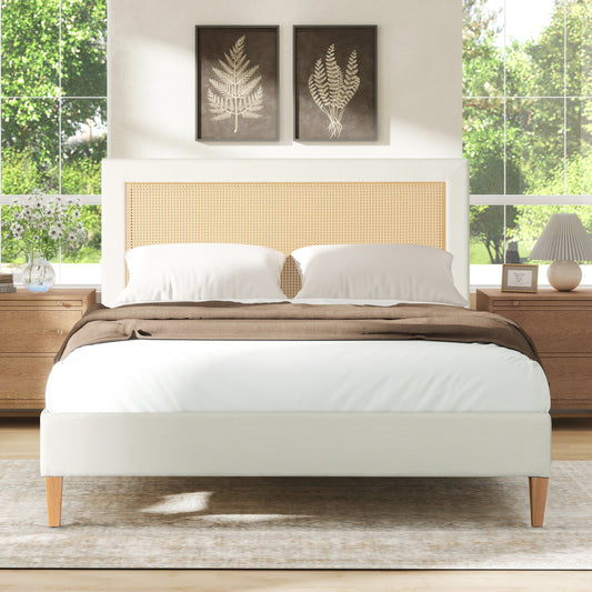 White upholstered bed with woven cane headboard and wooden legs