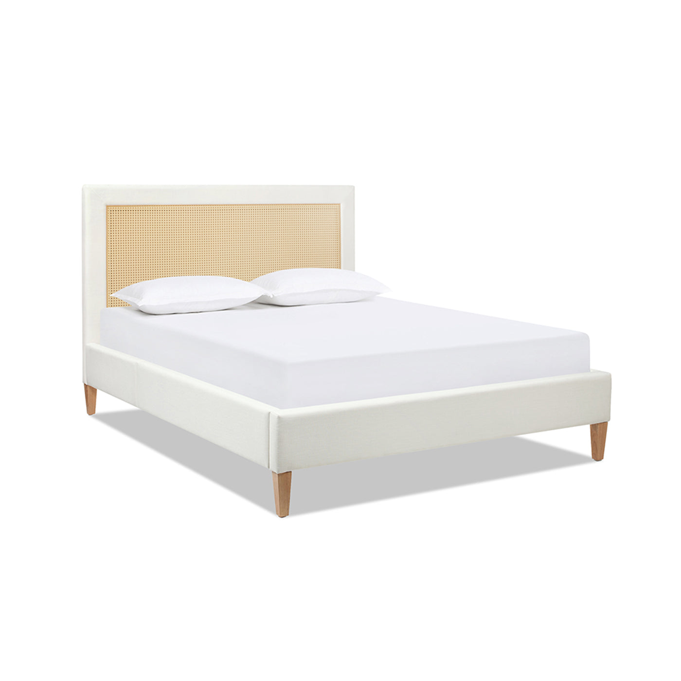 White upholstered bed with cane headboard and two pillows modern bedroom furniture