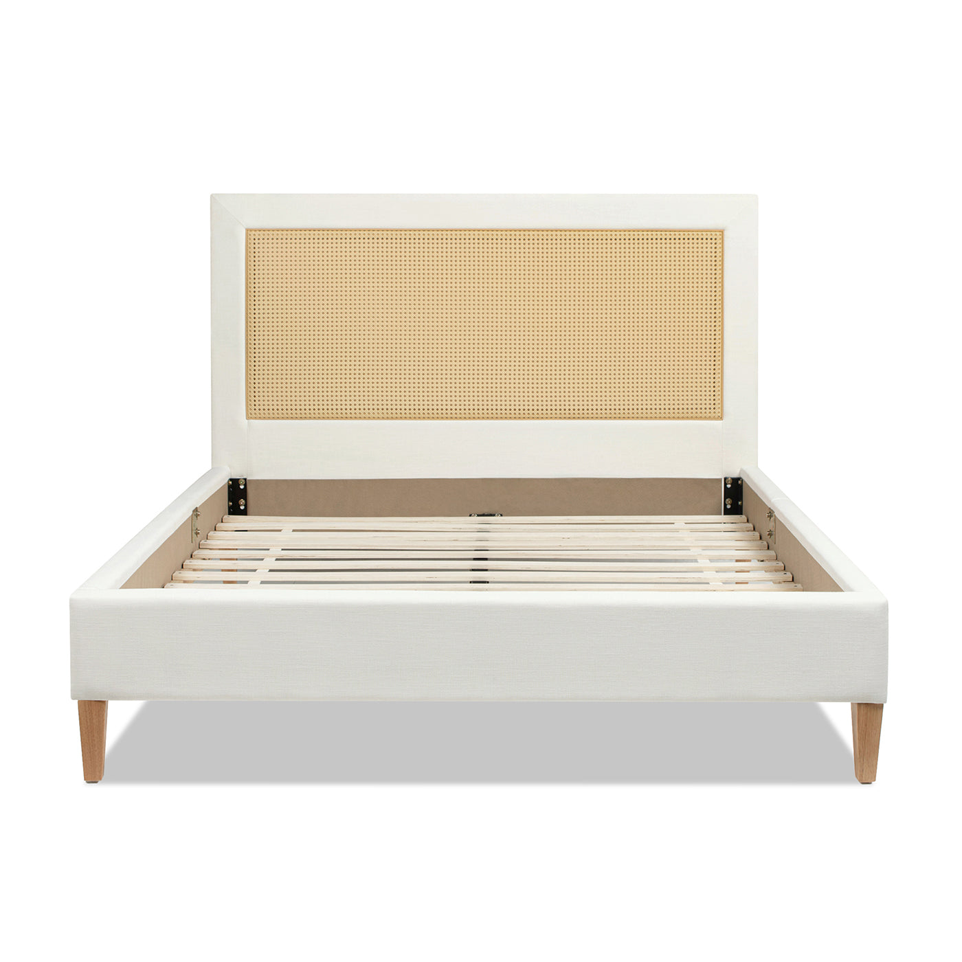 White upholstered bed frame with woven cane headboard and wooden legs